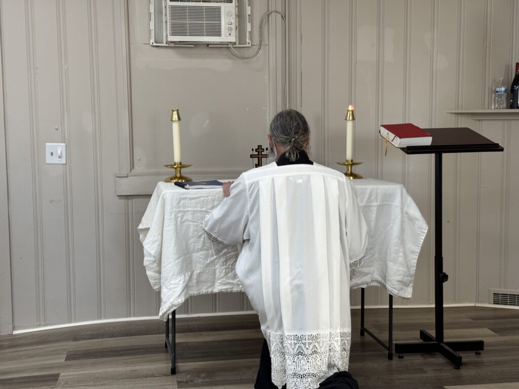 Father David kneeling